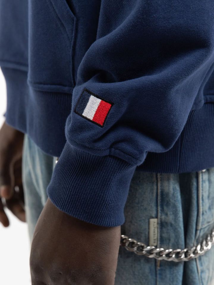 Detalle del puño en canalé con etiqueta de bandera francesa de la sudadera Reternity Saint Germain