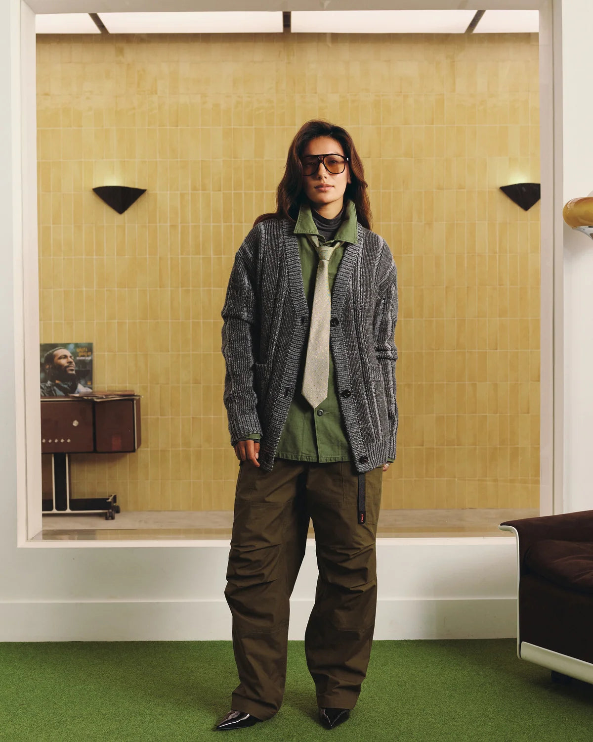 Modelo con cárdigan Staple Lockhart negro y pantalón verde, vista frontal