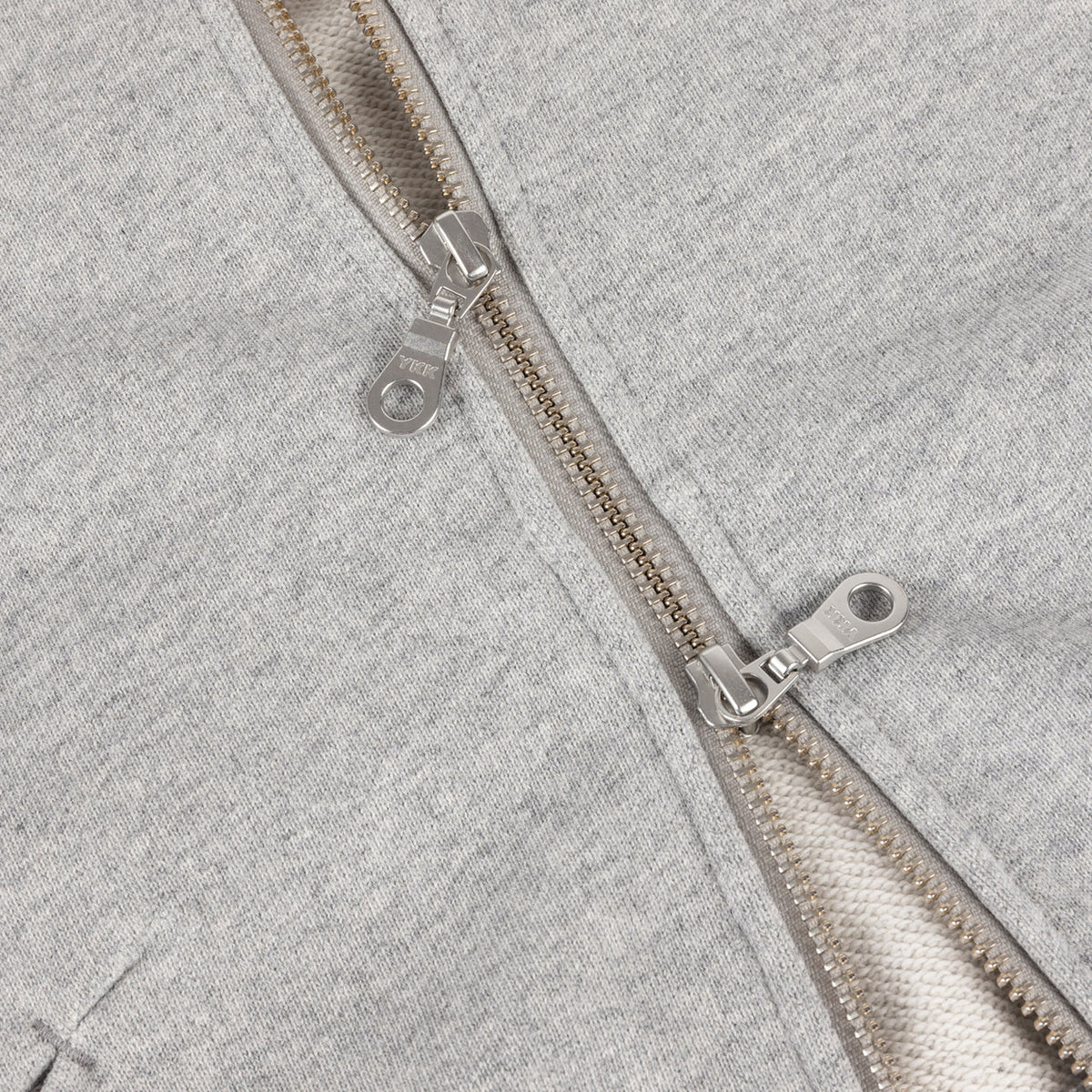 Detalle de la cremallera YKK de doble corredera de la sudadera Dime gris jaspeado
