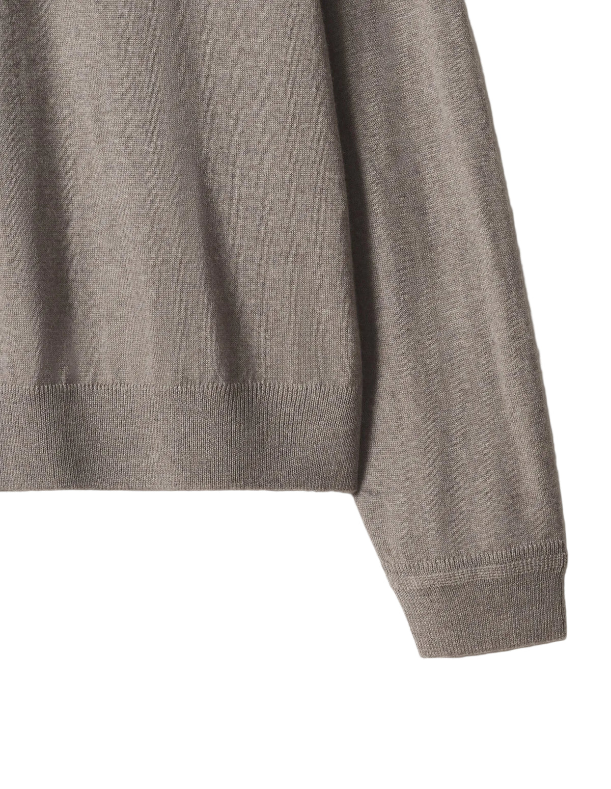 Detalle del puño acanalado y el tejido de punto del polo Maison Kitsuné beige